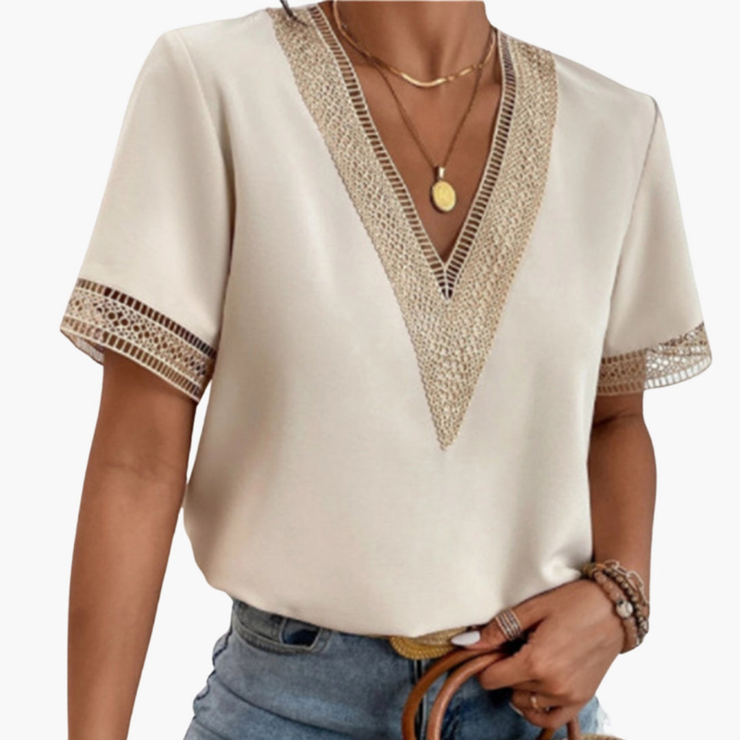 Women's cream V-neck short sleeve blouse showing detailed lace trim at the neckline and cuff hems.