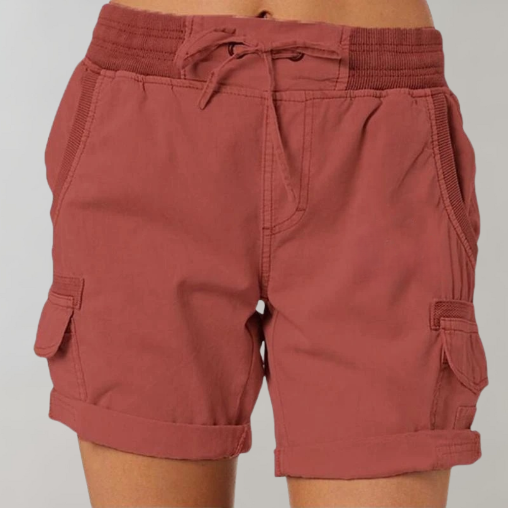 Women rust high waisted drawstring cargo shorts with cuffed hem and side pockets shown front view
