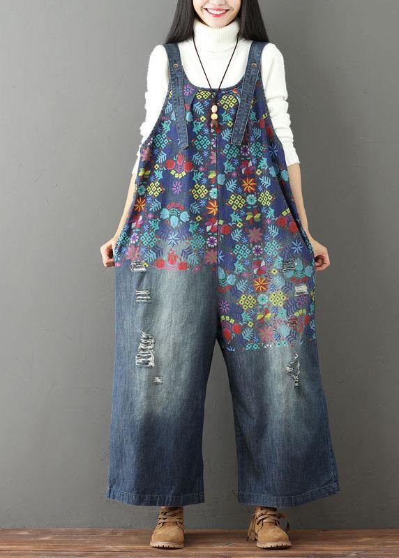 Women blue floral printed wide leg denim jumpsuit with distressed legs, front view