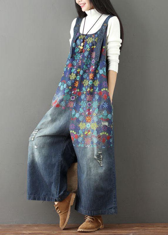 Women blue floral printed wide leg denim jumpsuit showing side pockets, slight angle