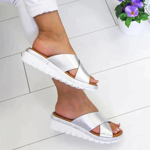 Women's silver casual platform sandals at an angle showing textured white sole