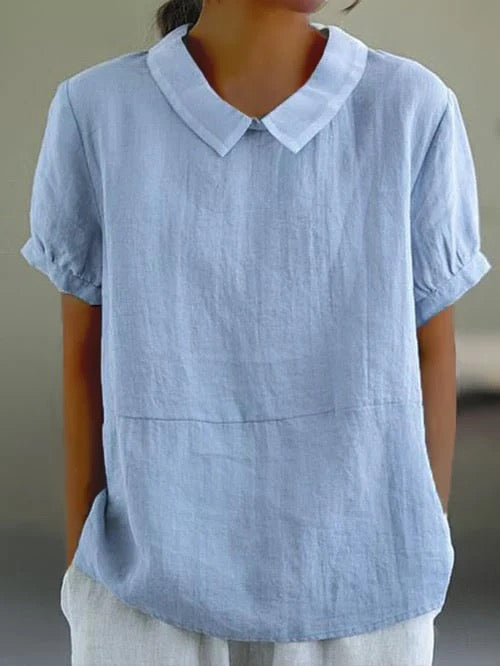 Women light blue short sleeve cotton blouse with rounded Peter Pan collar, front view on model