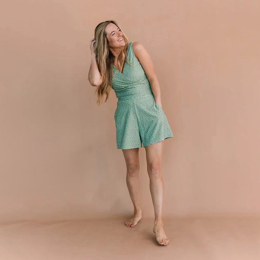 Women green polka dot sleeveless romper with V-neckline and pockets, full-body studio view