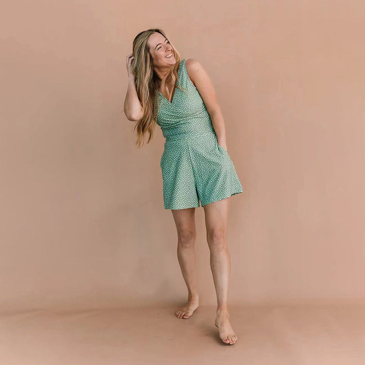 Women green polka dot sleeveless romper with V-neckline and pockets, full-body studio view