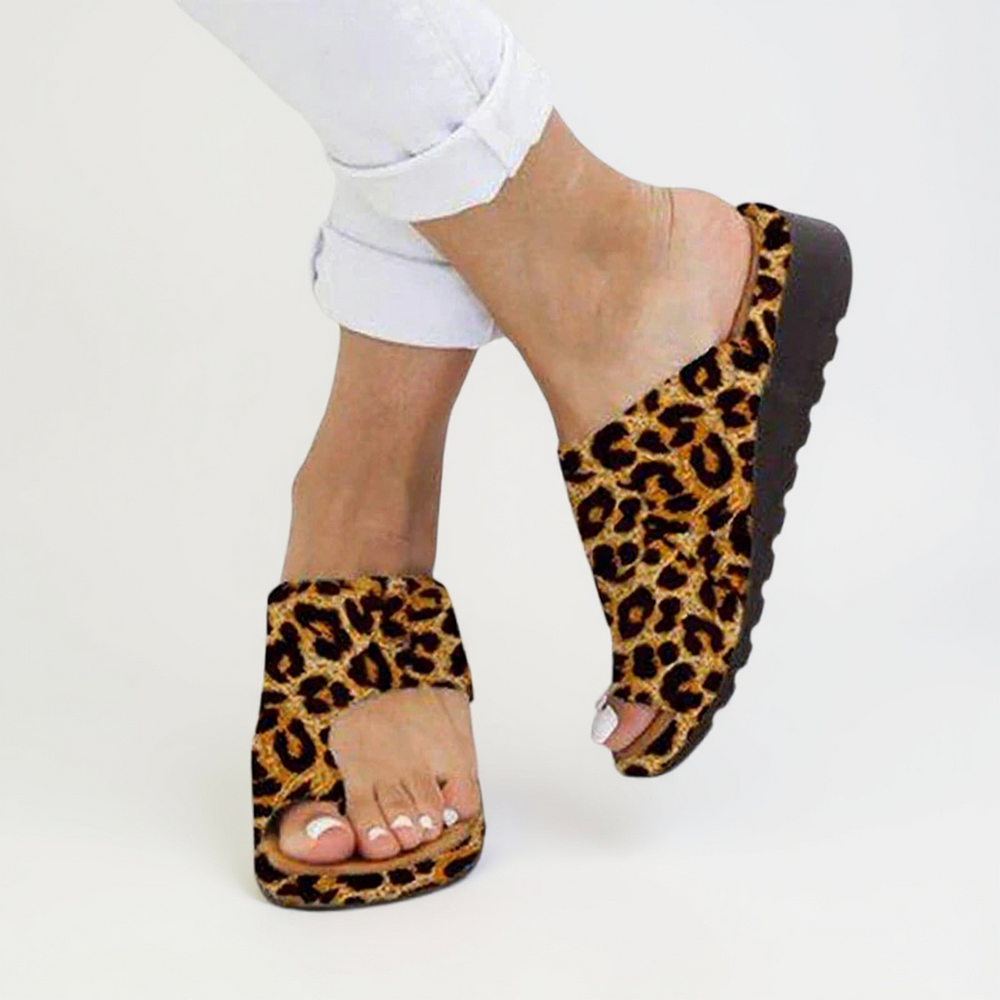 Women's leopard print toe split open toe sandals with an elevated ridged sole and wide strap.
