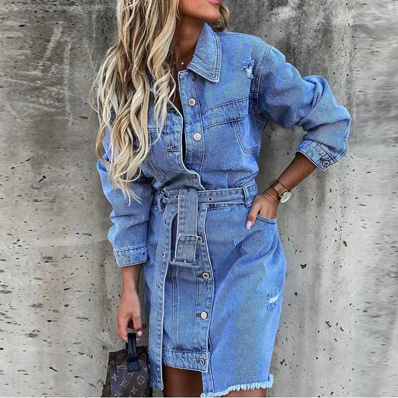 Women's blue distressed denim mini dress front view with long sleeves and belt