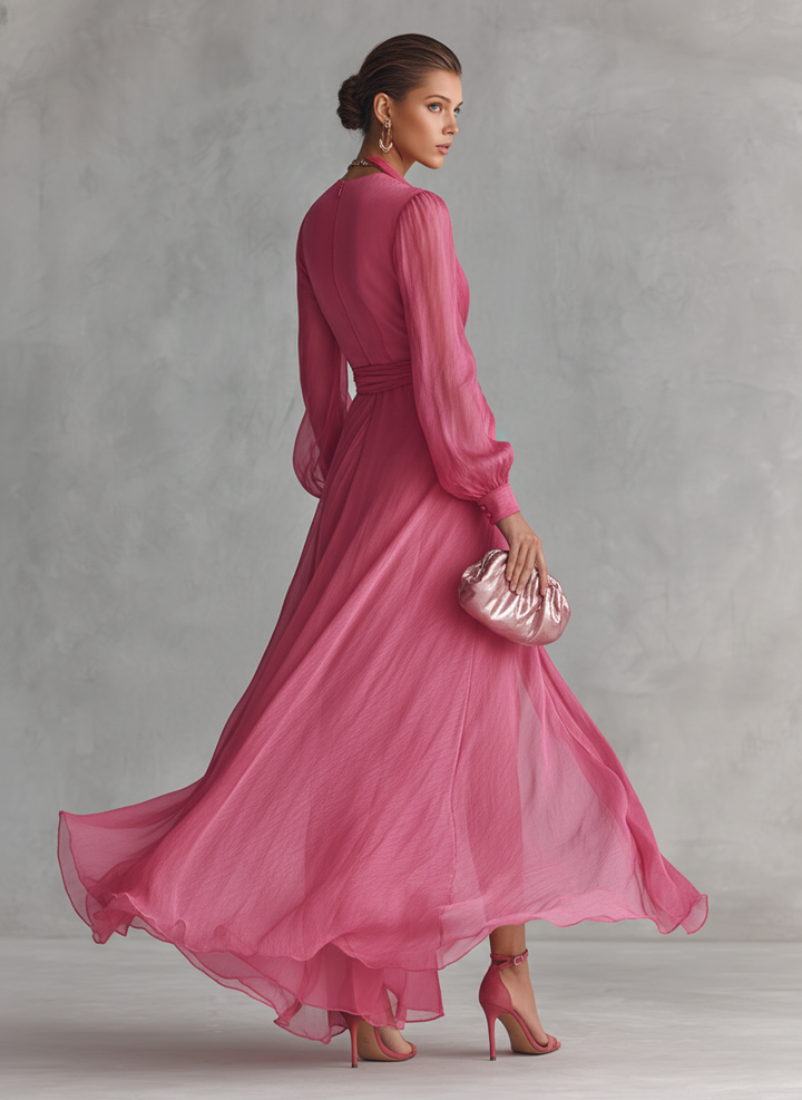 Women's pink wrap-style maxi dress with tie-waist and V-neck from the back view.