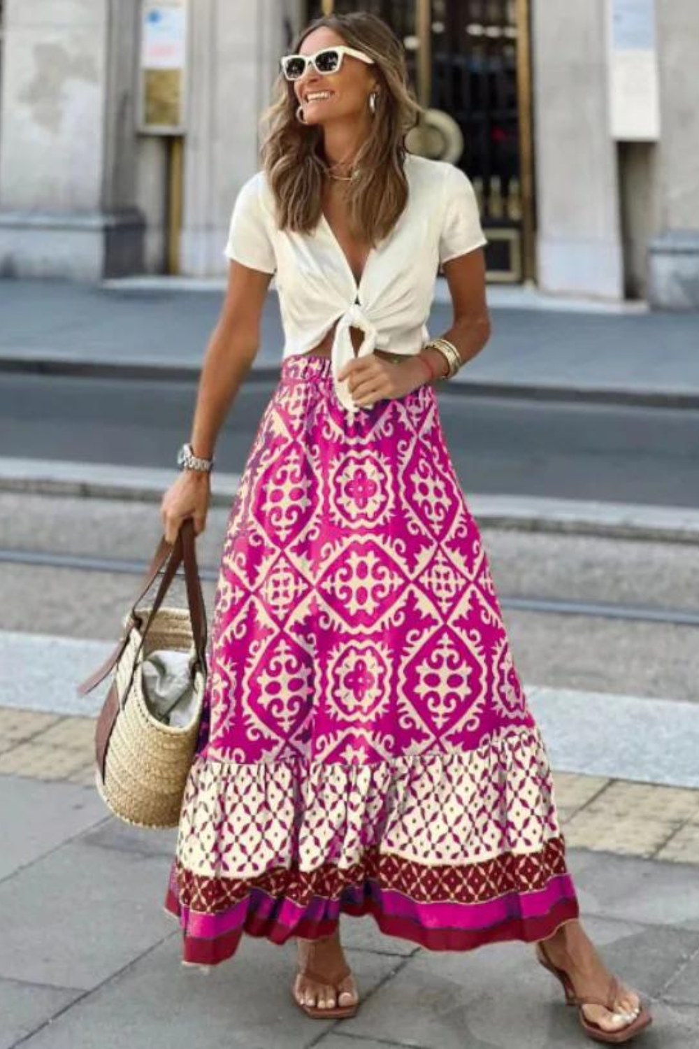 Women magenta printed A line maxi skirt with tiered hem, front view, casual pose