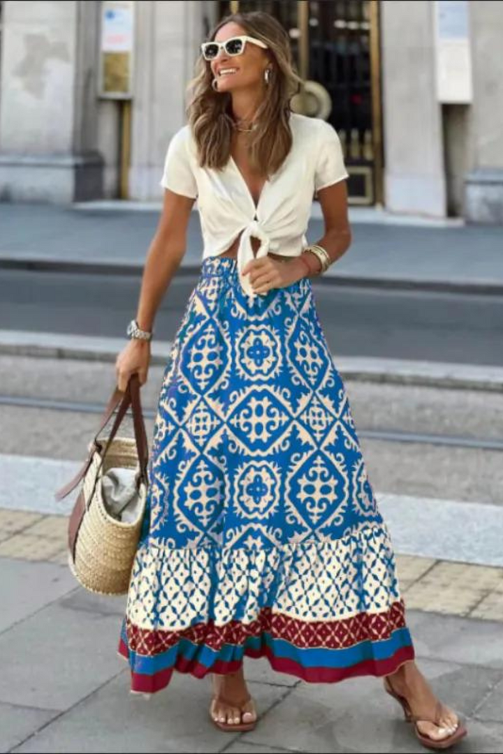 Women blue printed A line maxi skirt with tiered hem, front view, street setting