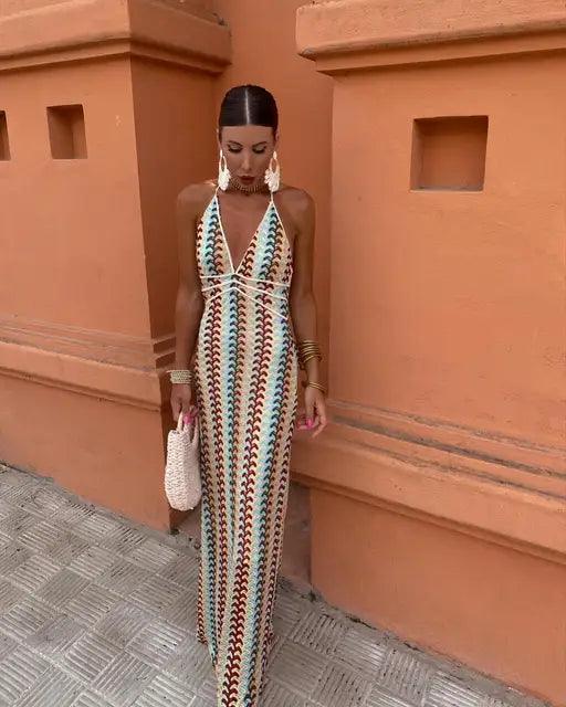 Women patterned halter V neck maxi dress in blue, orange, and brown with a front view