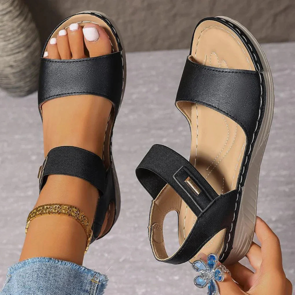 Women black two-strap adjustable sandals with open toe and cushioned sole, side view