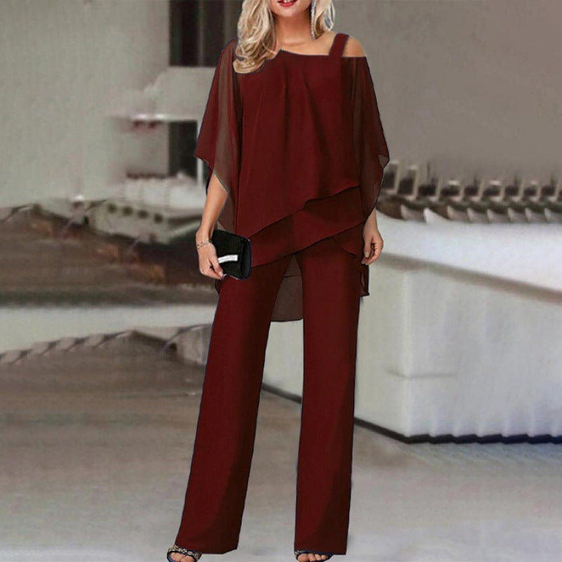 Women burgundy sleeveless off shoulder layered pant set, model with handbag