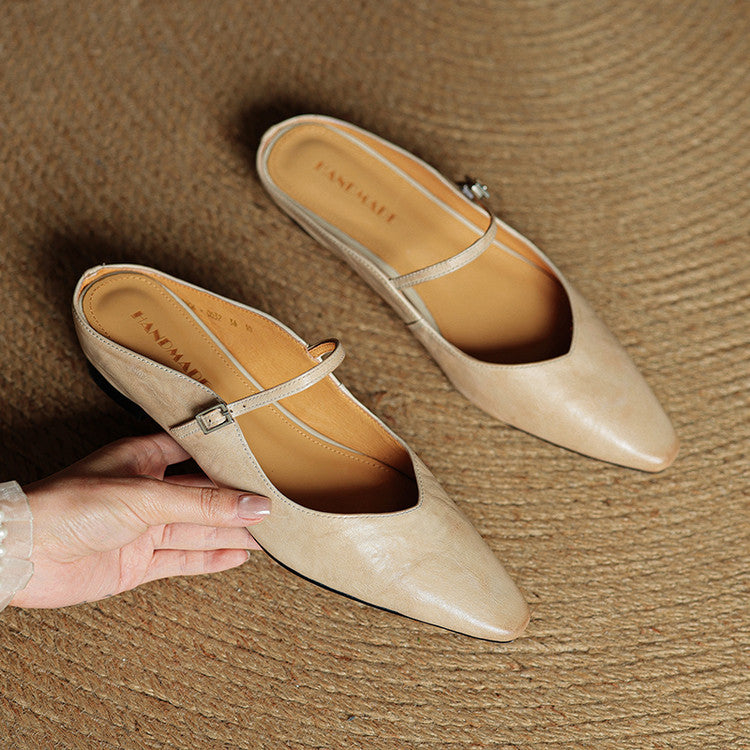 Pair of women beige slip-on mules with pointed toe and adjustable strap