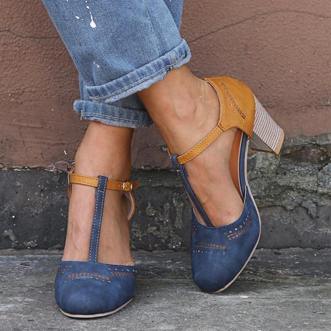 Women blue two-tone T-strap block heels with perforated toe detail, worn with cuffed jeans