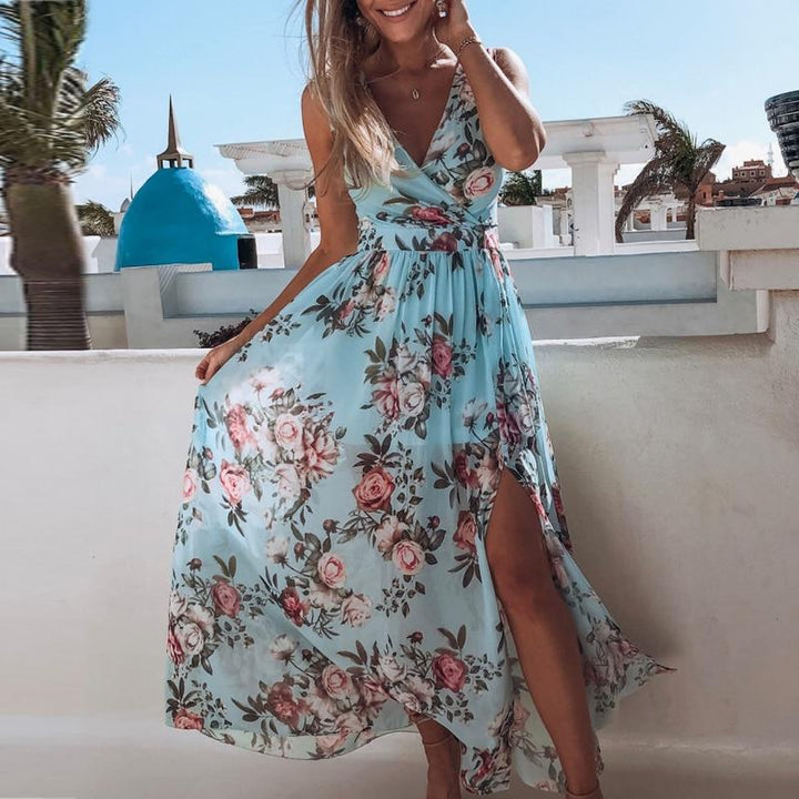 Women light blue floral maxi dress with V-neckline and high side slit, worn by model posing outdoors.