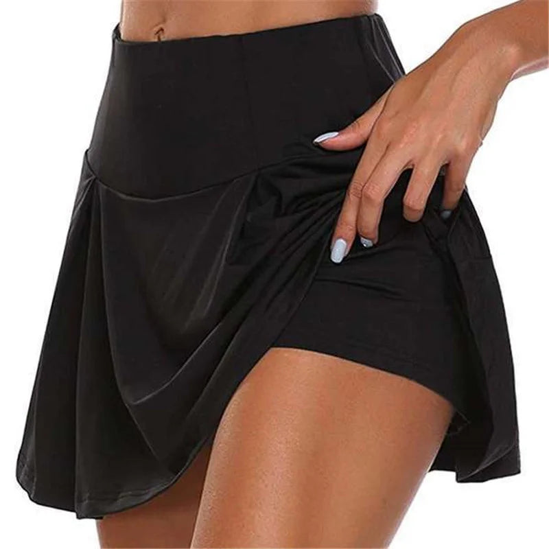 Women black high waisted mini skirt with front pleats and integrated shorts as seen from side view