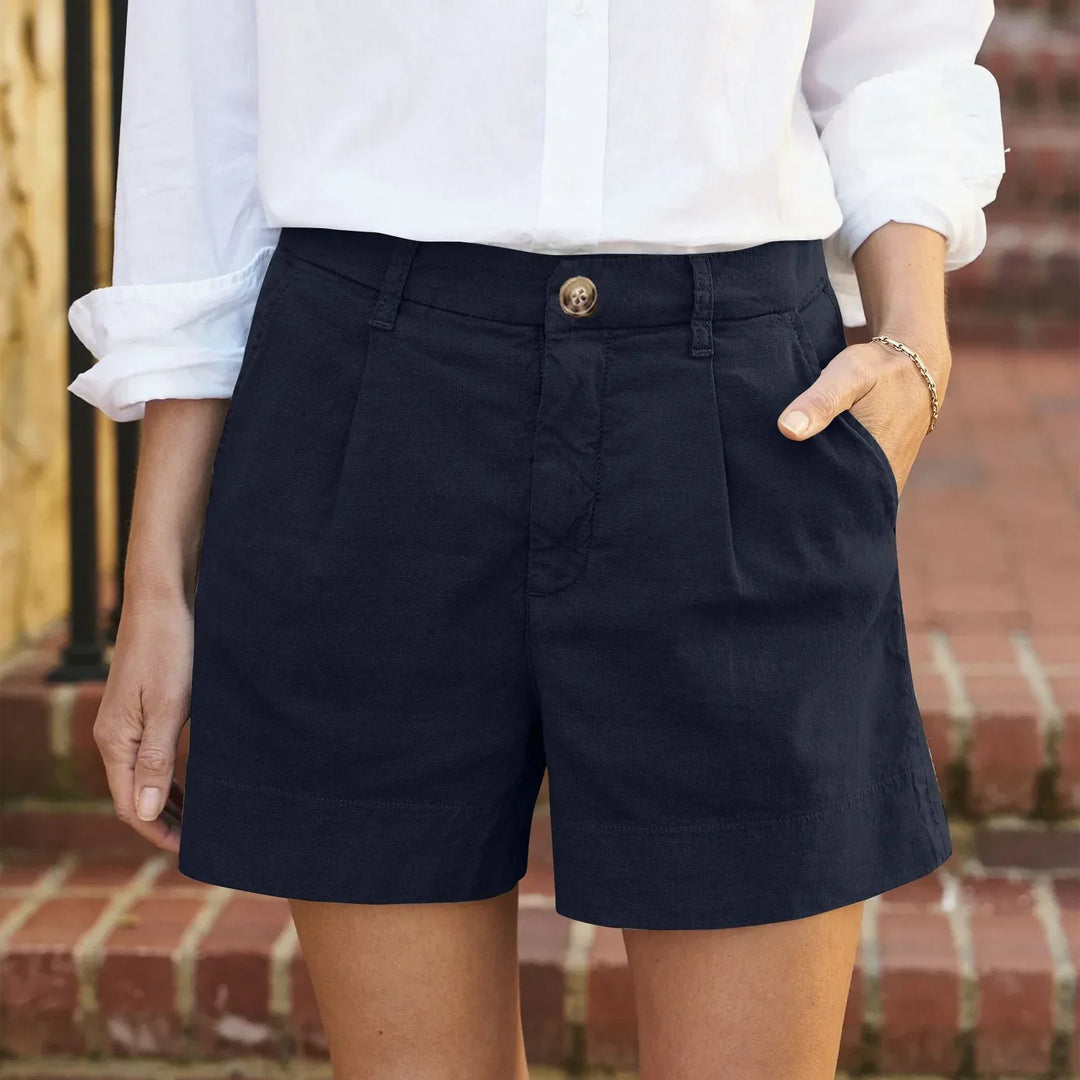 Women navy high waisted pleated shorts with side pockets and a white shirt