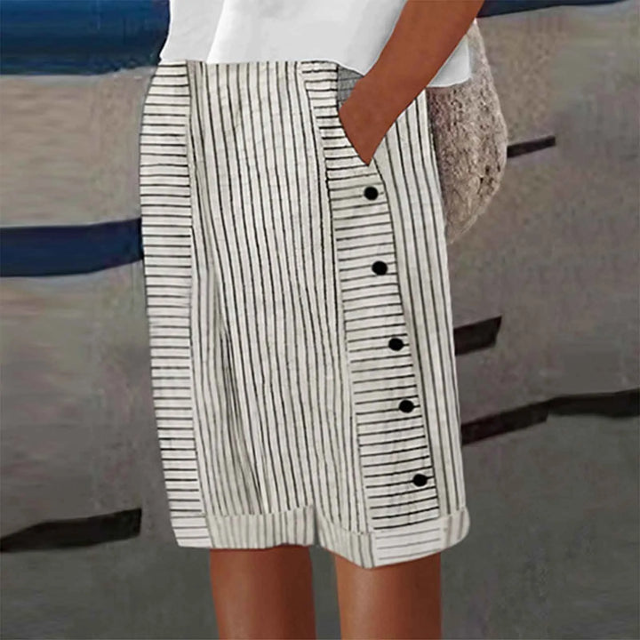 Women white black stripe high waist shorts with side buttons and cuffed hem, shown with pocket.