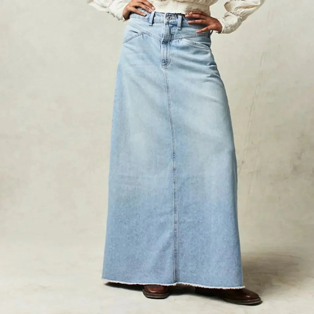 Women light blue denim maxi skirt with high waist and exposed button closure from the front