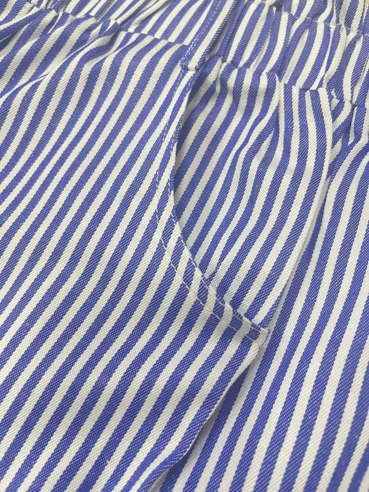 Close-up of blue and white striped fabric on shorts, showing pocket detail and seams