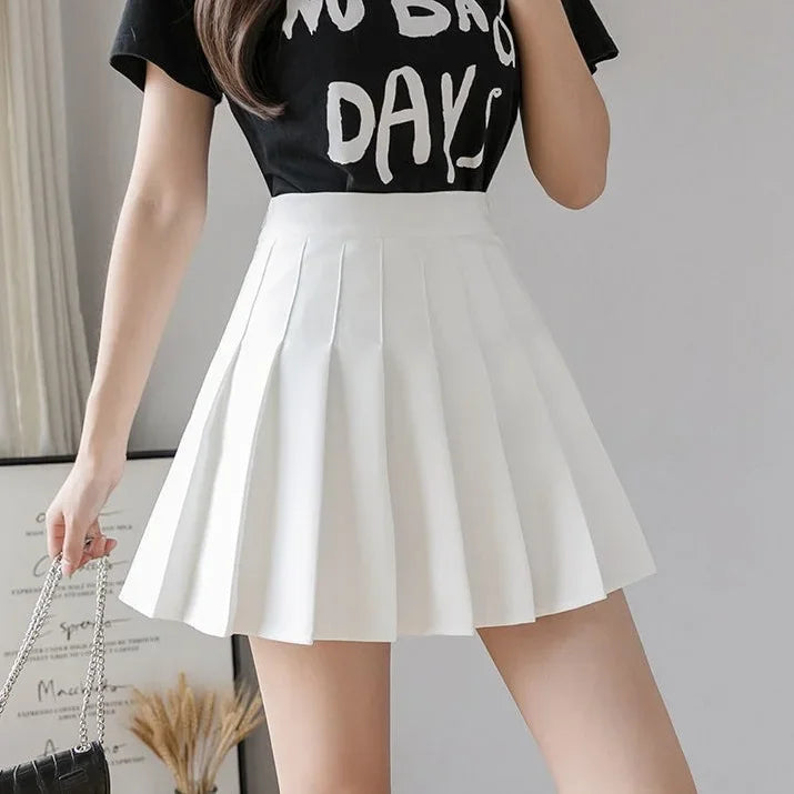 Women white high waist pleated mini skirt, front view, worn with a black graphic t-shirt.