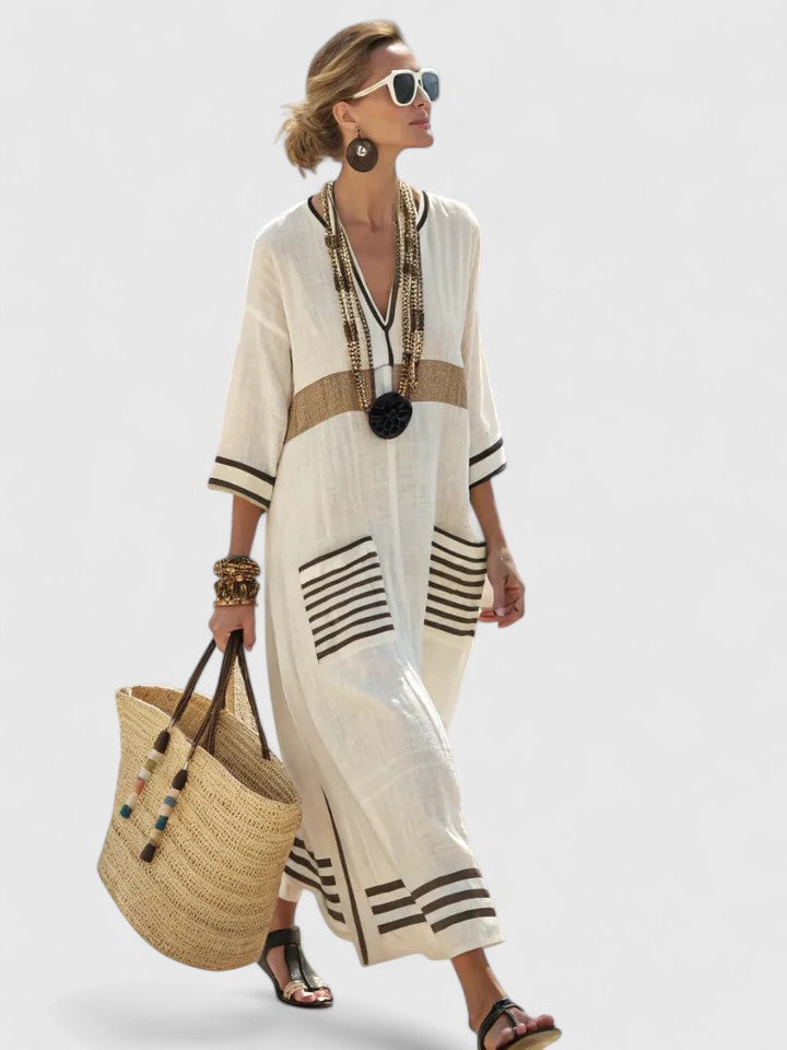 Women ivory and brown striped V-neck maxi dress with three-quarter sleeves and front pockets, front view.