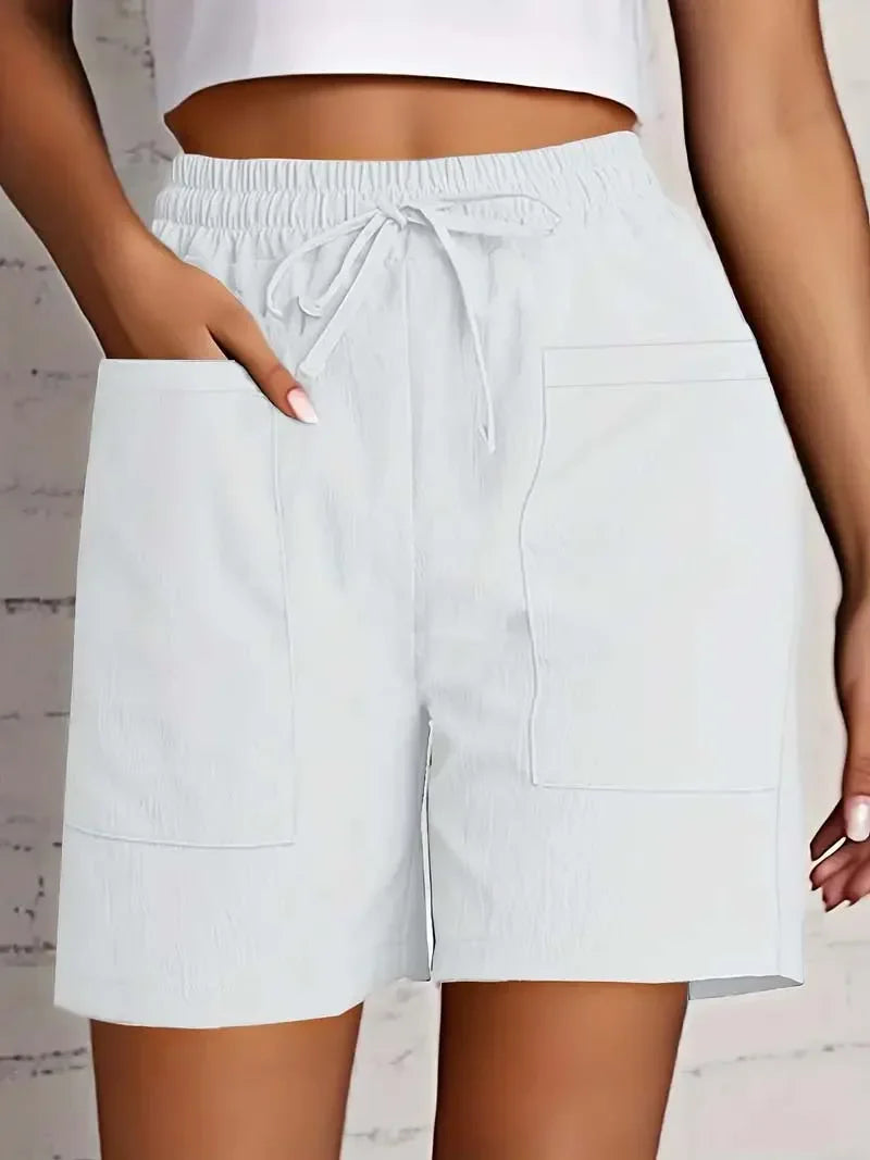 Women white casual shorts with elasticated waist and adjustable drawstring, showing front patch pockets.