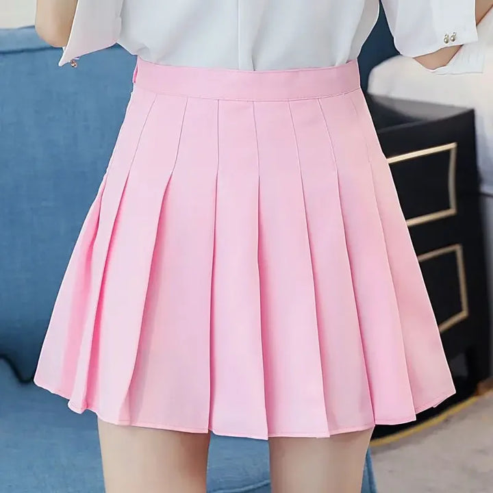 Women pink high waist pleated mini skirt, close-up front view, highlighting the pleated design.