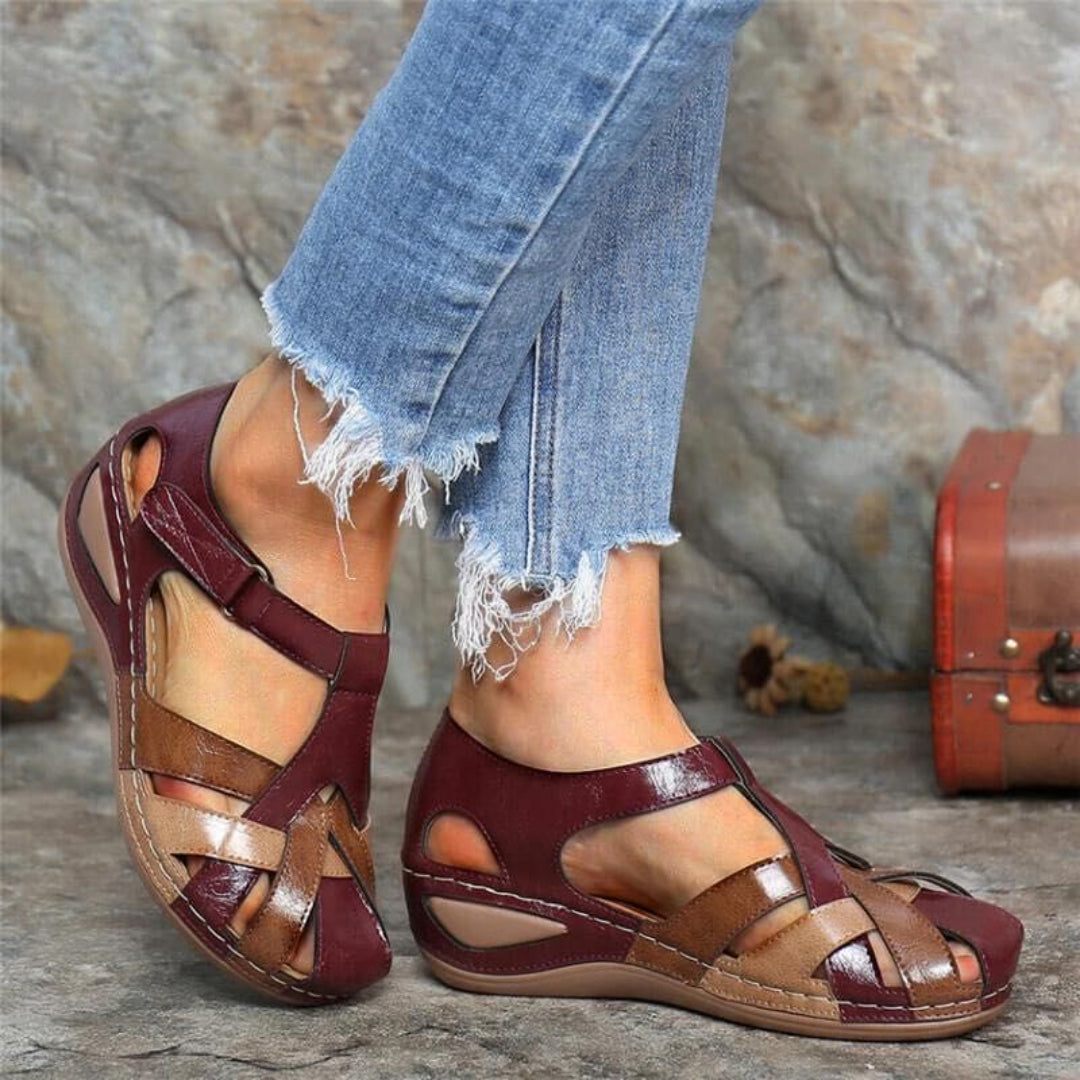 Women burgundy colorblock closed toe wedge sandals with woven straps and buckle closure, side view.