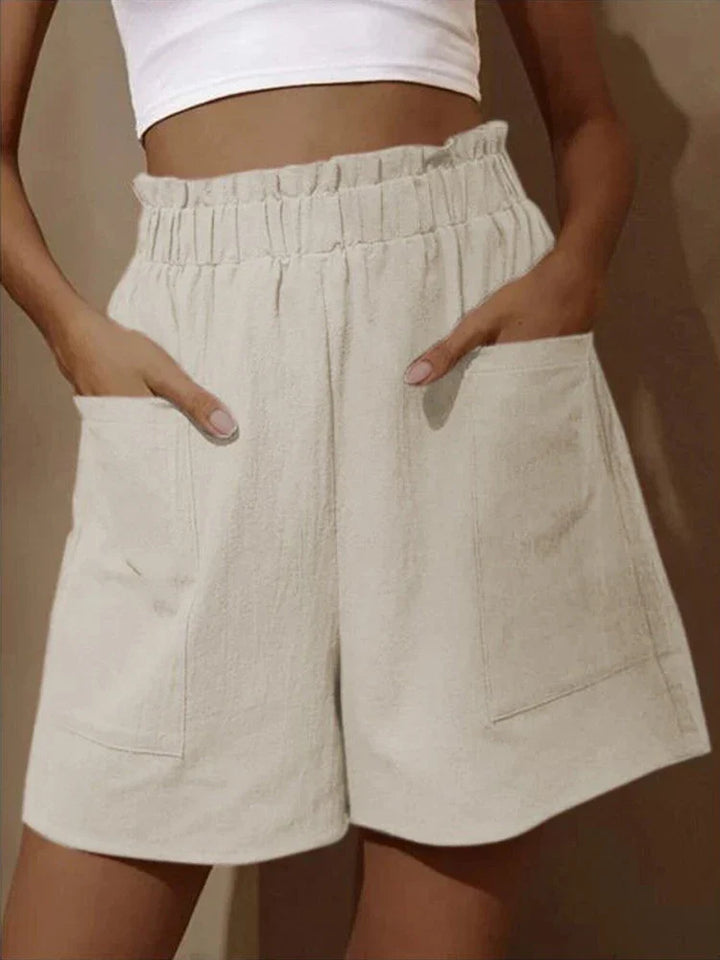 Women's off-white high waist paperbag shorts with visible elastic waistband and patch pockets.