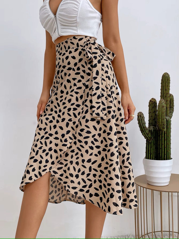 Women light beige floral print midi wrap skirt with side tie, worn with a white crop top.