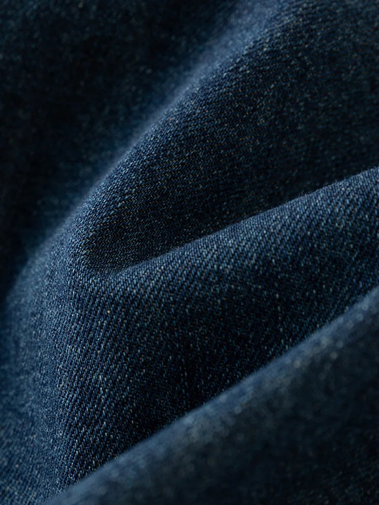 Close up view of the blue denim fabric texture on the midi dress