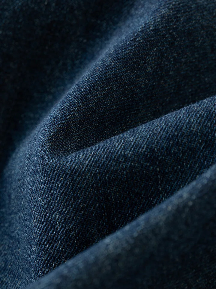 Close up view of the blue denim fabric texture on the midi dress