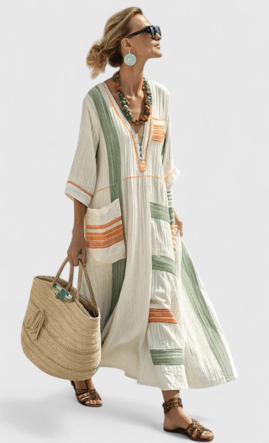 Women ivory and green striped V-neck maxi dress with orange accents on front pockets, dynamic pose.