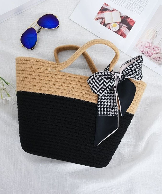 Women two-tone beige and black knit tote bag with a decorative houndstooth scarf and sunglasses.