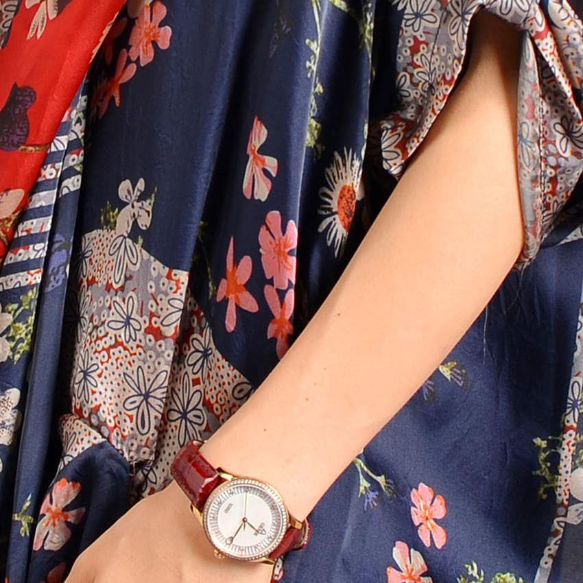 Close up of red and navy patchwork floral print fabric on women's maxi dress