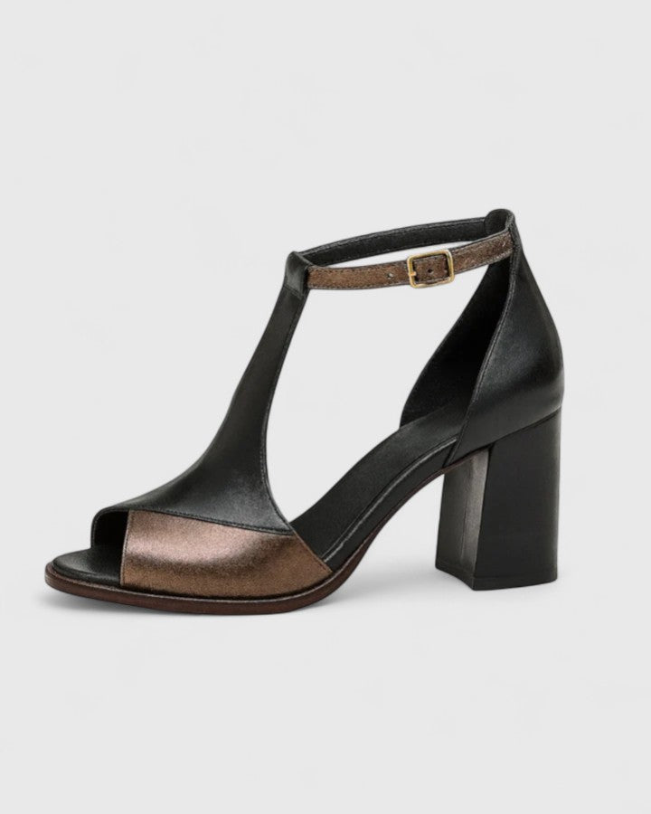 Women two-tone black and bronze block heel sandal with T-strap and adjustable ankle strap.