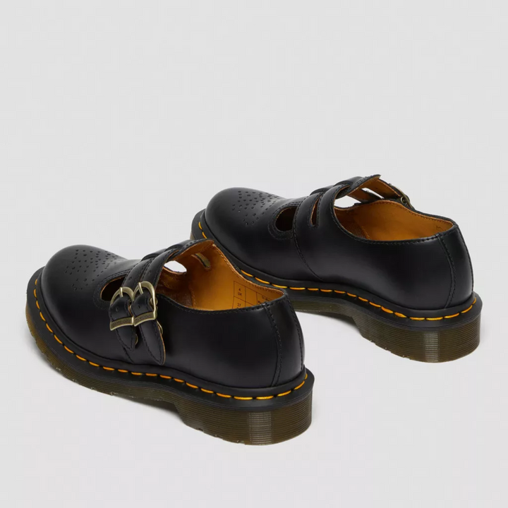 Pair of women black double buckle Mary Janes showing rear angle and sole detail
