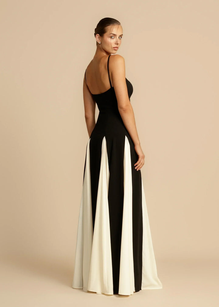 Women black and white formal maxi dress, rear side view showing back neckline and skirt details.