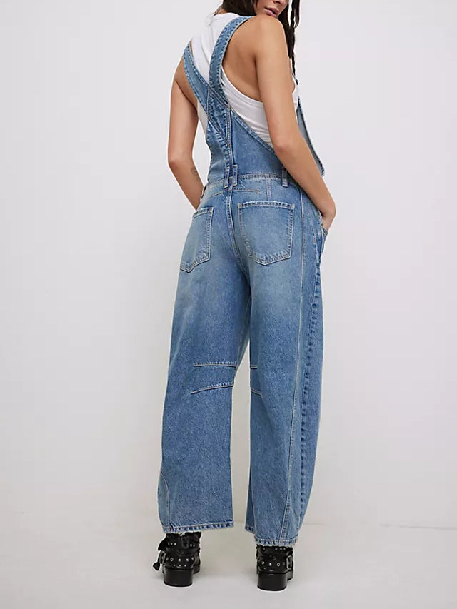 Women light wash denim wide leg overalls with back patch pockets and knee panels, rear view