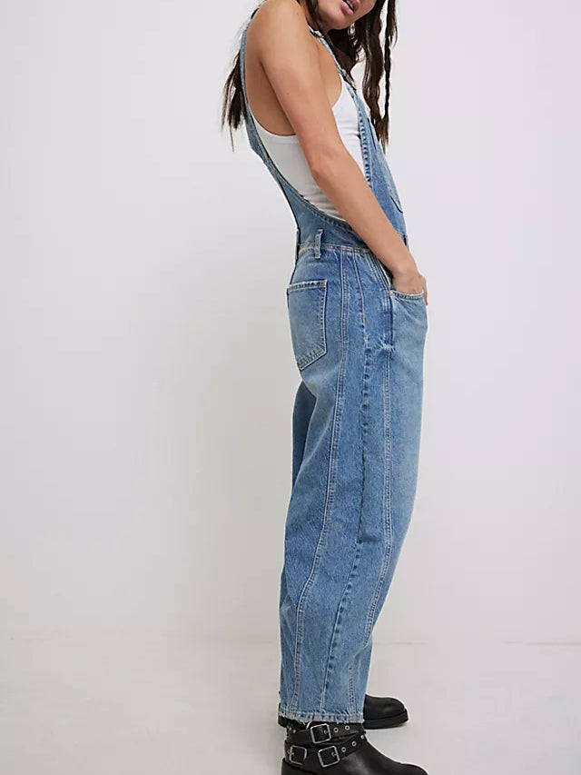 Women light wash denim wide leg overalls with side buttons and hip pockets, side view