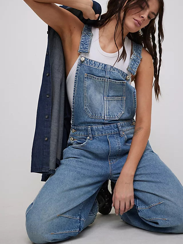 Women light wash denim wide leg overalls with bib front pocket and metal hardware, detailed view