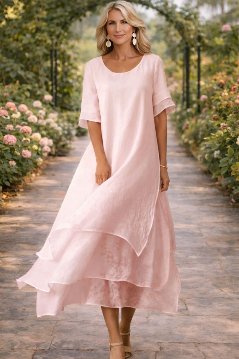 Women pink scoop neck layered midi dress with short sleeves, front view with a slight breeze