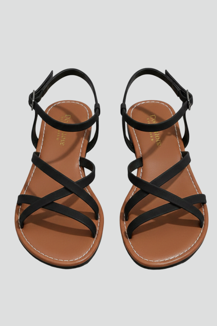Pair of women's black flat sandals with criss-cross toe and ankle straps
