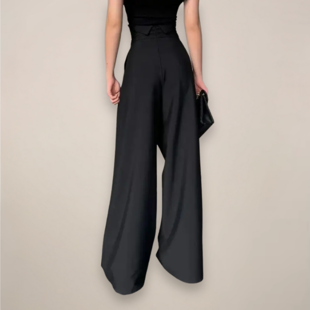 Women black high waisted wide leg slacks, back view showing the flowing leg design.