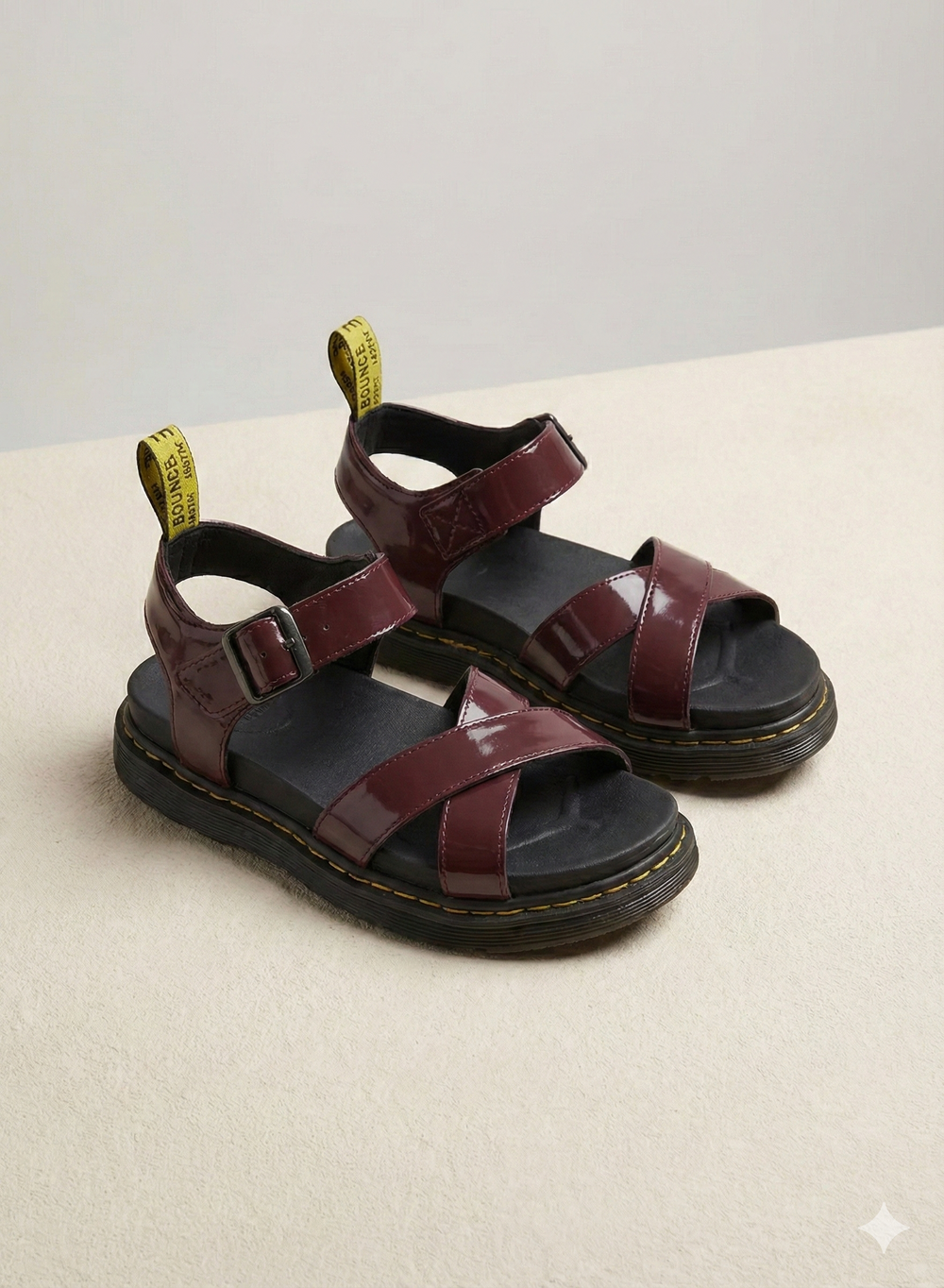 Women burgundy patent platform sandals with criss-cross front straps, side view.