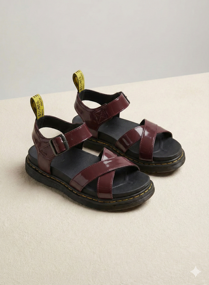 Women burgundy patent platform sandals with criss-cross front straps, side view.