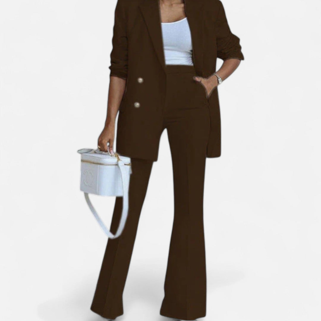 Women's brown double breasted blazer and high waist flared pants set, with hand in pocket.