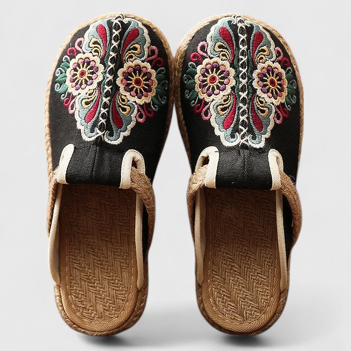 Women black floral embroidered flat mule shoes with woven jute sole top view