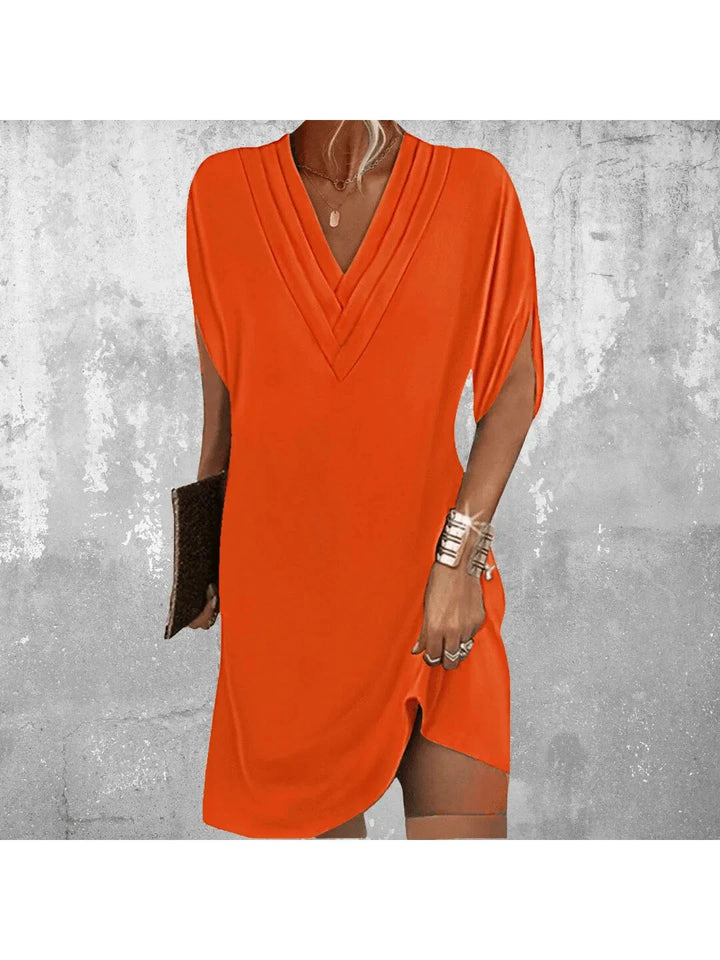 Women orange V neck mini dress with a relaxed fit and layered V-neck detail on torso